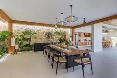 a dining room with a large wooden table and chairs at Villa Selena Space Luxury 4BR 15m Pool BBQ Staffed in Seminyak