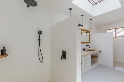 a bathroom with a shower and a sink at Villa Selena Space Luxury 4BR 15m Pool BBQ Staffed in Seminyak
