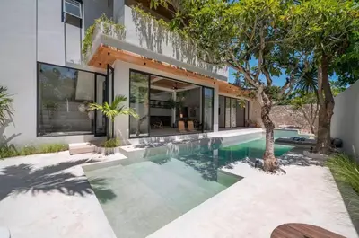 a swimming pool in the backyard of a house at Villa Batu, Superb 4BR beachside in Canggu