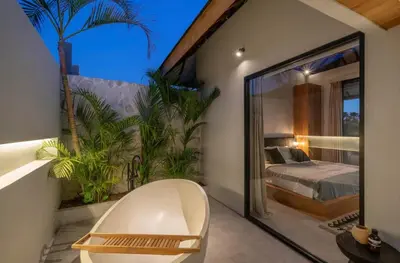 a bedroom with a bed and a large window at Villa Batu, Superb 4BR beachside in Canggu