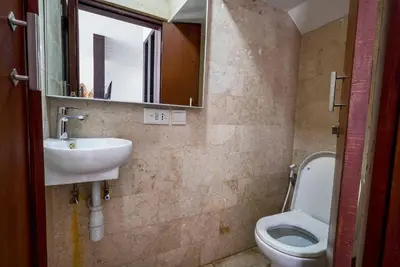 a bathroom with a sink and a toilet at Norm Villa Kuta in Kuta