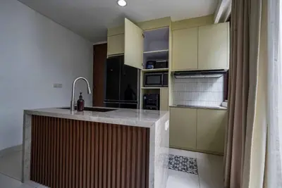 a kitchen with a sink and a counter top at Norm Villa Kuta in Kuta