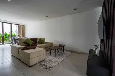 a living room with a couch and a table at Norm Villa Kuta in Kuta