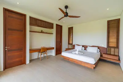 a bedroom with a bed and a ceiling fan at Luxury Rosa Village - 4 Bedrooms Walkable to Beach in Jimbaran