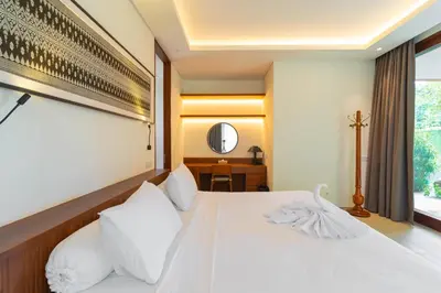 a bedroom with a white bed and a window at Luxury Rosa Village - 4 Bedrooms Walkable to Beach in Jimbaran