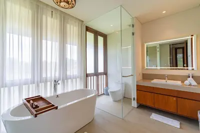 a bathroom with a tub and a sink and a mirror at Luxury Rosa Village - 4 Bedrooms Walkable to Beach in Jimbaran