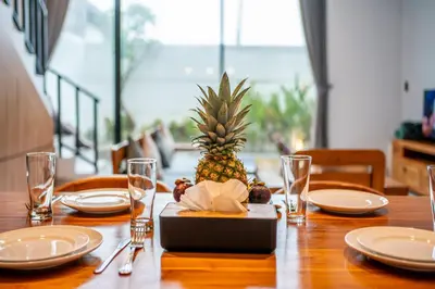 a wooden table with a pineapple on top of it at Luxury 2BR Villas in Seminyak Central in Seminyak