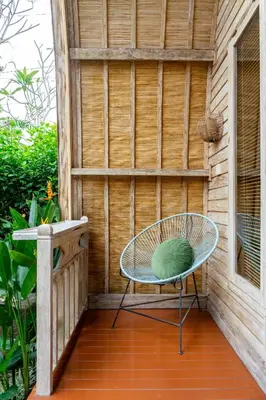 a table and a chair on a patio at Puri Sekar Bali in Pesanggaran