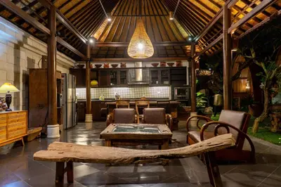 a living room with a table and chairs and a ceiling at Puri Sekar Bali in Pesanggaran