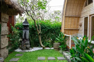 a garden with a small tree and a bird house at Puri Sekar Bali in Pesanggaran