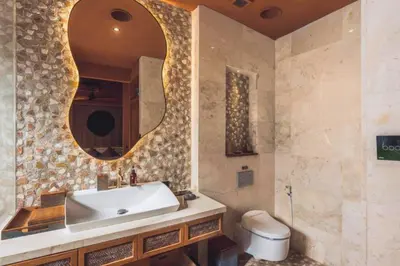 a bathroom with a sink and a mirror and a toilet at Yaseera Aesthetic 1 BR Grand Smart Private Pool Villa in Seminyak