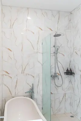 a bathroom with a shower with a tub at 3BRVilla Minutes from Seminyak, Petitenget, Canggu in Kerobokan
