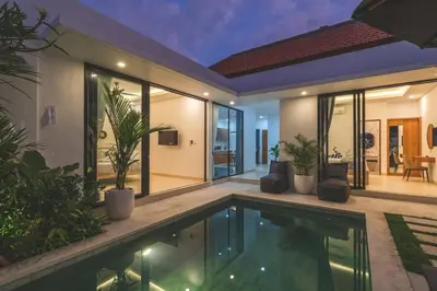 a villa with a swimming pool and a house at 3BRVilla Minutes from Seminyak, Petitenget, Canggu in Kerobokan
