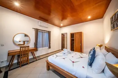 a bedroom with a bed with a mirror and a desk at Prime Seminyak 2BR Villas in Seminyak