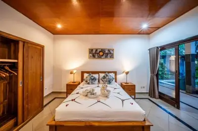 a bedroom with a bed with two stuffed animals on it at Prime Seminyak 2BR Villas in Seminyak