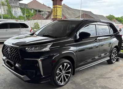 a black suv parked in a parking lot at Mobil Veloz Q CVT in Ngurah Rai International Airport