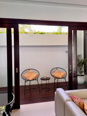 a living room with two chairs and a couch at Villa Hale Mahina, Bali in Kerobokan