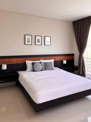 a bedroom with a large bed with white sheets and pillows at Villa Hale Mahina, Bali in Kerobokan