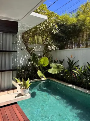 a swimming pool in a garden with plants at Villa Hale Mahina, Bali in Kerobokan