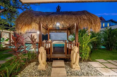 a gazebo in a resort with two statues at Villa Samsara 3BR Pool Villa Near Berawa Beach in Canggu