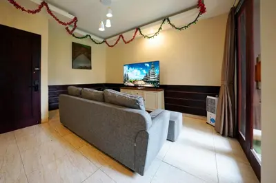 a living room with a couch and a tv at 6 Bedrooms Pool Twin Villa in West Sanur in Sanur