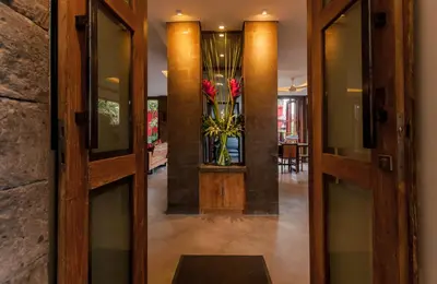 a hallway with doors and a vase of flowers at 6 BDR Boutique villa in heart of Seminyak in Seminyak