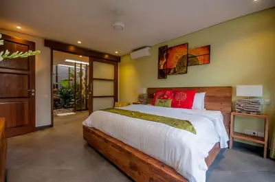 a bedroom with a large bed with white and red pillows at 6 BDR Boutique villa in heart of Seminyak in Seminyak