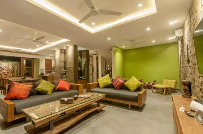 a living room with two couches and a green wall at 6 BDR Boutique villa in heart of Seminyak in Seminyak