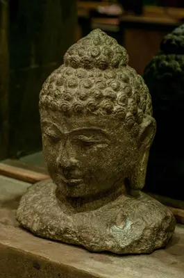 a stone statue of a head on a table at Boutique Modern Luxury in the Heart of Seminyak in Seminyak