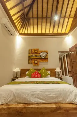 a bedroom with a large bed and a clock on the wall at Boutique Modern Luxury in the Heart of Seminyak in Seminyak