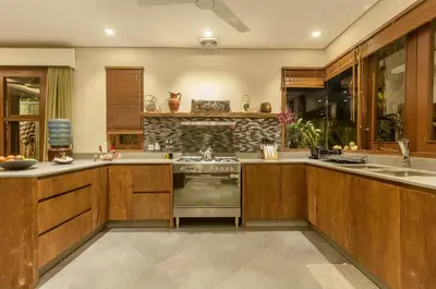 a kitchen with wooden cabinets and a stove top oven at Boutique Modern Luxury in the Heart of Seminyak in Seminyak