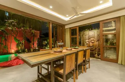 a dining room with a long wooden table with chairs at Boutique Modern Luxury in the Heart of Seminyak in Seminyak