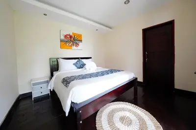 a bedroom with a large white bed and a rug at 3Bedrooms Villa with Pool West Sanur - Casa Del Sol in Sanur