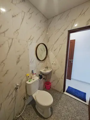 a bathroom with a toilet and a sink at Kubu Semangka in Sanur