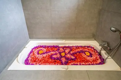 a bath tub with a flower design in it at Villa Aditya Seminyak in Seminyak