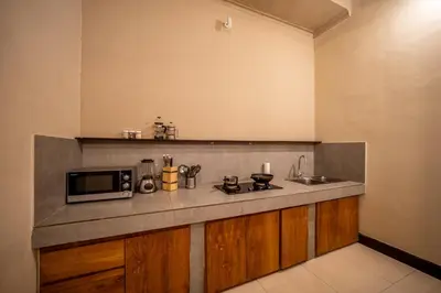 a kitchen with a counter top with a microwave at Villa Aditya Seminyak in Seminyak