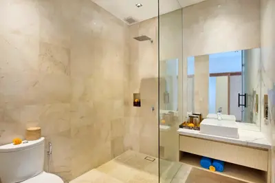 a bathroom with a shower and a toilet and a sink at Halina Cozy 2 BR Private Pool Villa With Bathtub in Legian