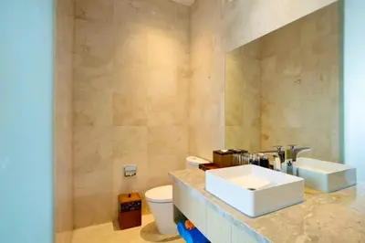 a bathroom with a sink and a toilet at Heleina Elegant 3 BR Royal Private Pool Villa With Jacuzzi in Legian