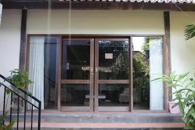 an entrance to a building with glass doors at Kundalini Shakta Yoga Meditasi in Denpasar
