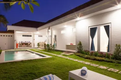 a house with a swimming pool in the yard at Cozy 2br villa at the beach in Canggu