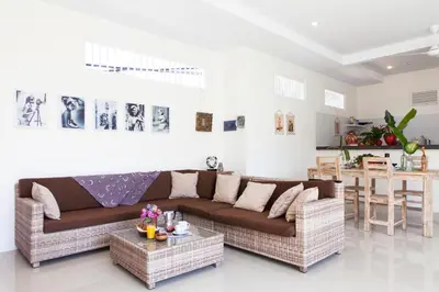 a living room with a couch and a table at Cozy 2br villa at the beach in Canggu