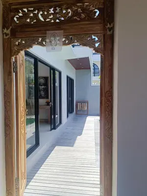 an entrance to a house with a wooden doorway at Villa Delila in Canguu in Canggu