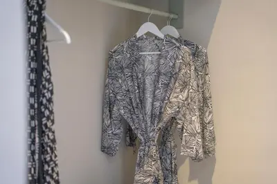 a suit on a hanger hanging on a wall at Anam Mani New Room Central Seminyak in Seminyak