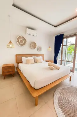 a bedroom with a large bed in a room at Blush Elegance 2 BR Villa in Umalas in Canggu