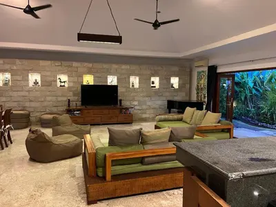 a living room with couches and a flat screen tv at Beachside Luxury Private Villa in Sanur in Sanur