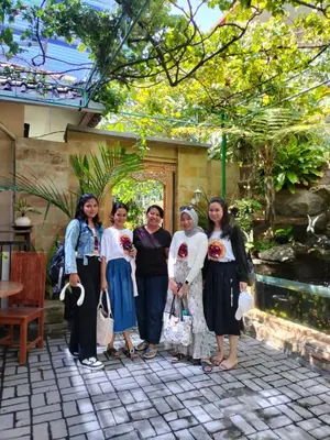 a group of women posing for a picture in a garden at Pujihouse One in Legian