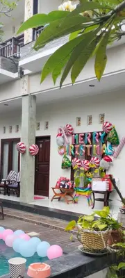 a building with candy canes on the side of it at Pujihouse One in Legian