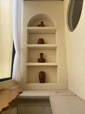 a room with shelves with vases on them at LoftStyle Villa with nice Private Plunge Pool in Kerobokan