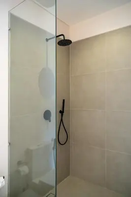 a shower with a glass door in a bathroom at Villa Aito, Luxury 3 BD Private Villa near Beach - Bali in Seminyak