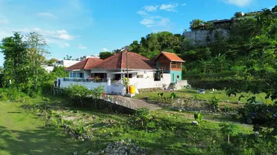 a house on the side of a hill at Nuansa Timur Residence in Jimbaran